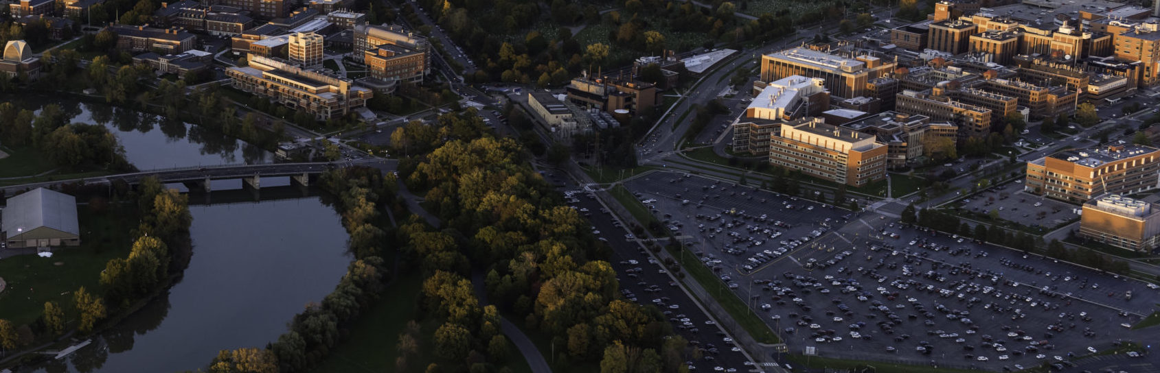 Aerial photo of University of Rochester's River Campus and Medical Center along with downtown Rochester, NY in in the evening