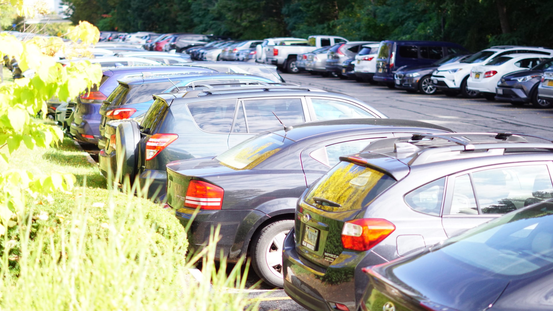 Cars and trucks parked in lot on River Campus