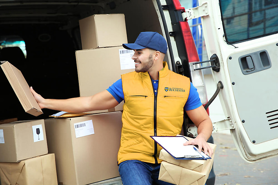 Employee loading boxes onto truck.