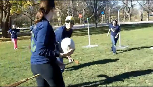 Students running with brooms