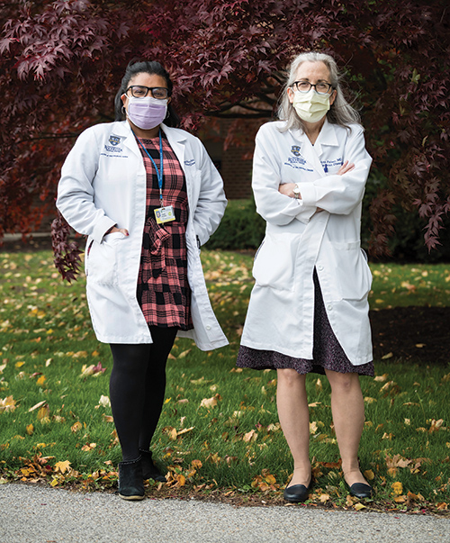 portrait of Angela Branche and Ann Falsey, two doctors wearing white coats and face masks. 