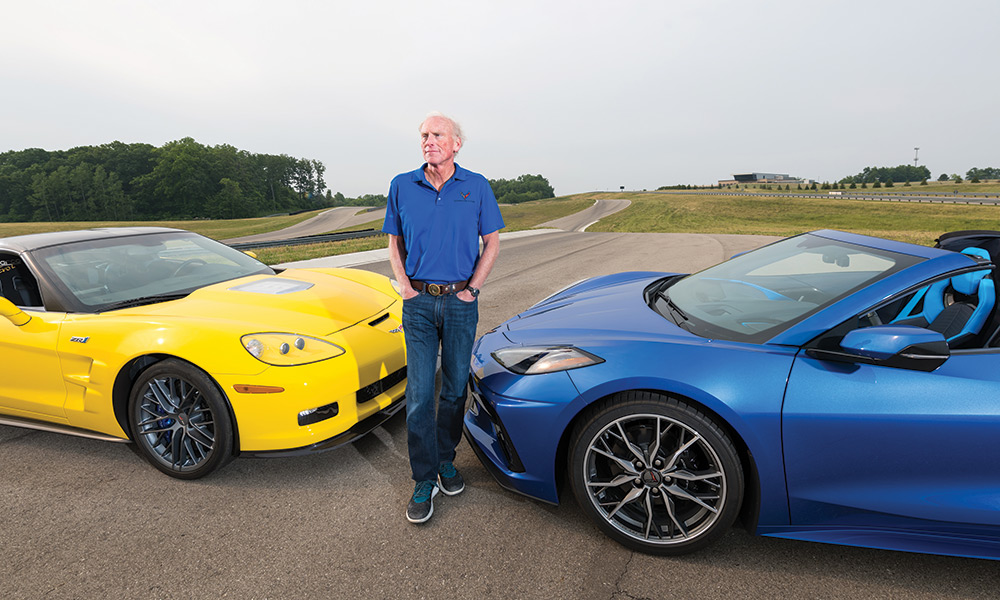 photo of Corvette engineer Tadge Juechter with blue Corvette and a yellow Corvette