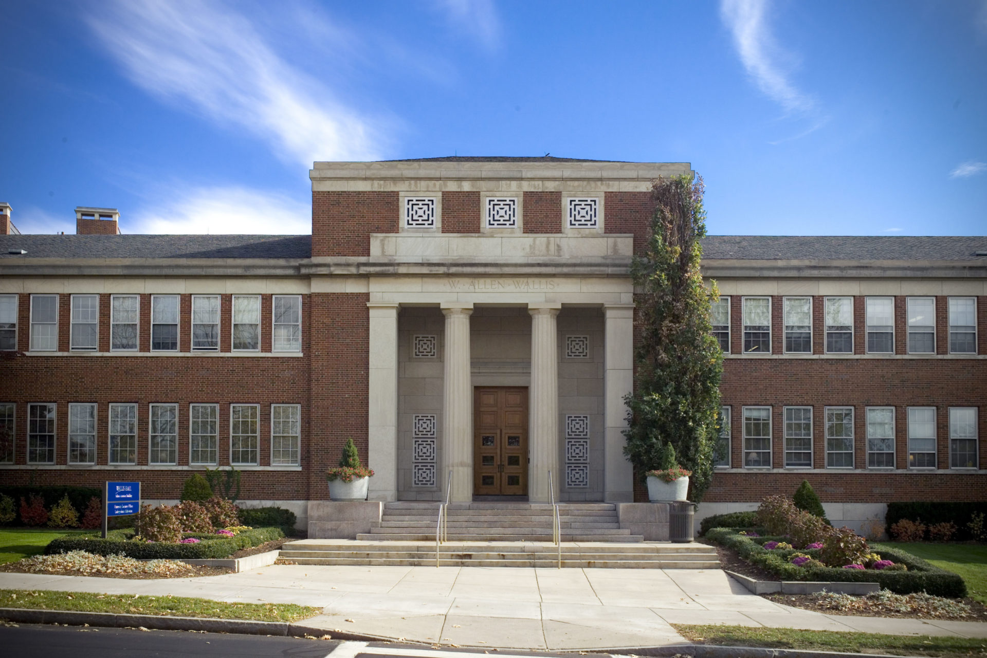 Exterior view of Wallis Hall on the University of Rochester's River Campus. Built in 1957 as the administration building, this was the first time in the University's then 107-year existence that a separate building was provided for the administration. Previously, administrative offices were housed in other academic and residential facilities. The administration building was renamed in 1998 as Wallis Hall for W. Allen Wallis, the sixth president of the University of Rochester.Wallis Hall, a red brick structure in the Greek revival style, faces the Genesee River from its location on Wilson Boulevard. The building houses University administration offices, the admissions office, public relations, and human resources offices. Photo by University of Rochester, Brandon Vick