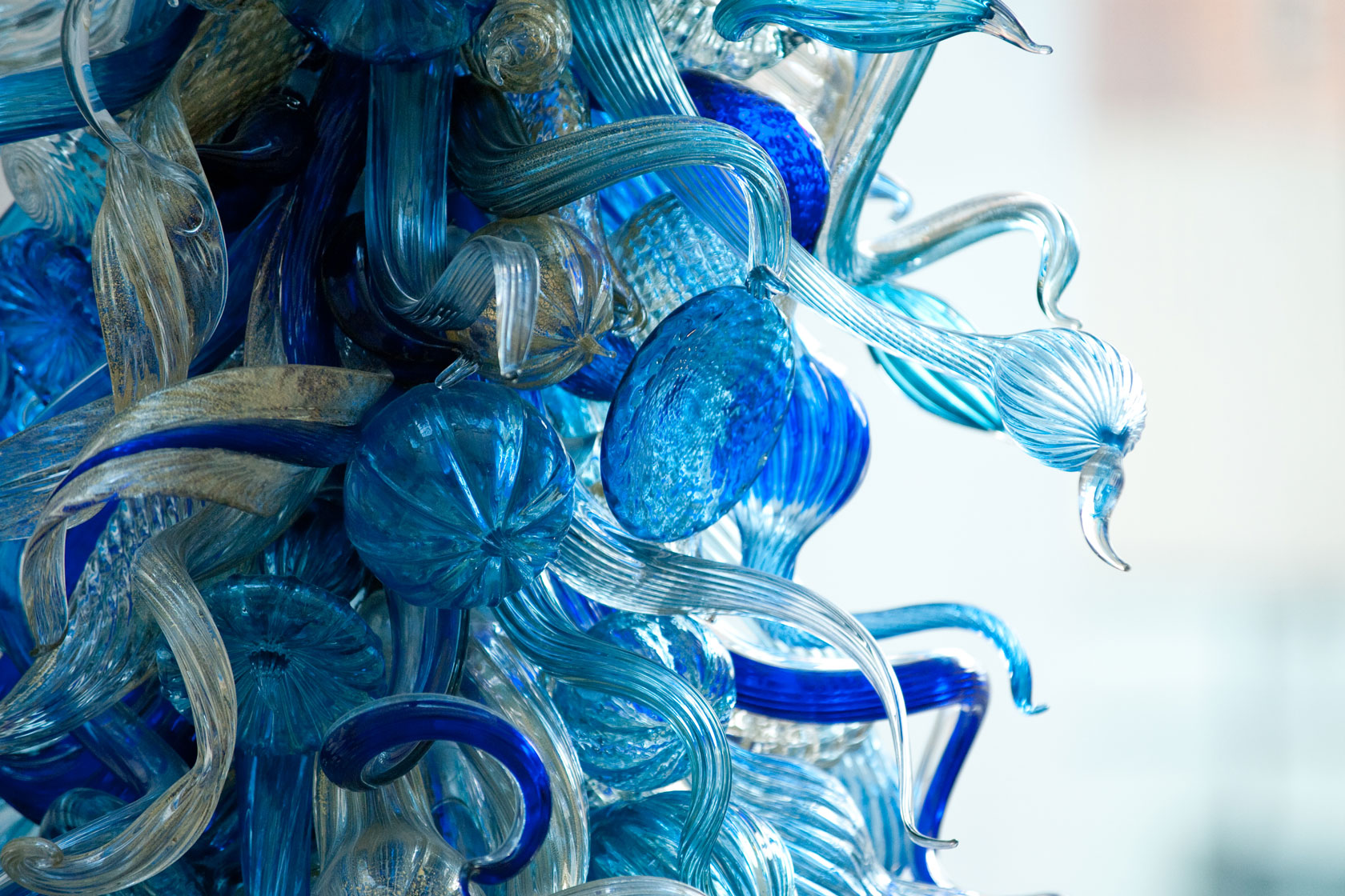 A large, translucent glass sculpture depicting a jellyfish, showcasing intricate details and flowing tentacles.