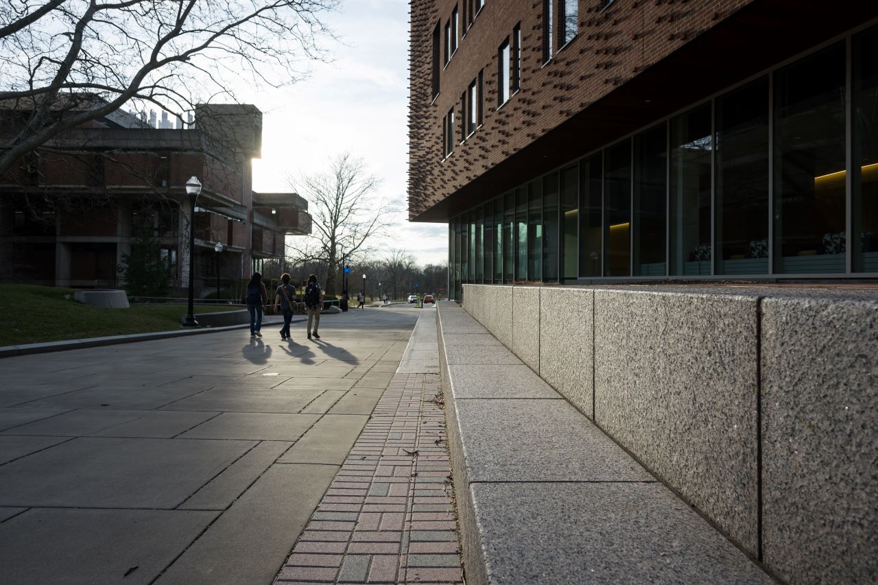 Students walking across the Hajim Quad on the University of Rochester campus.