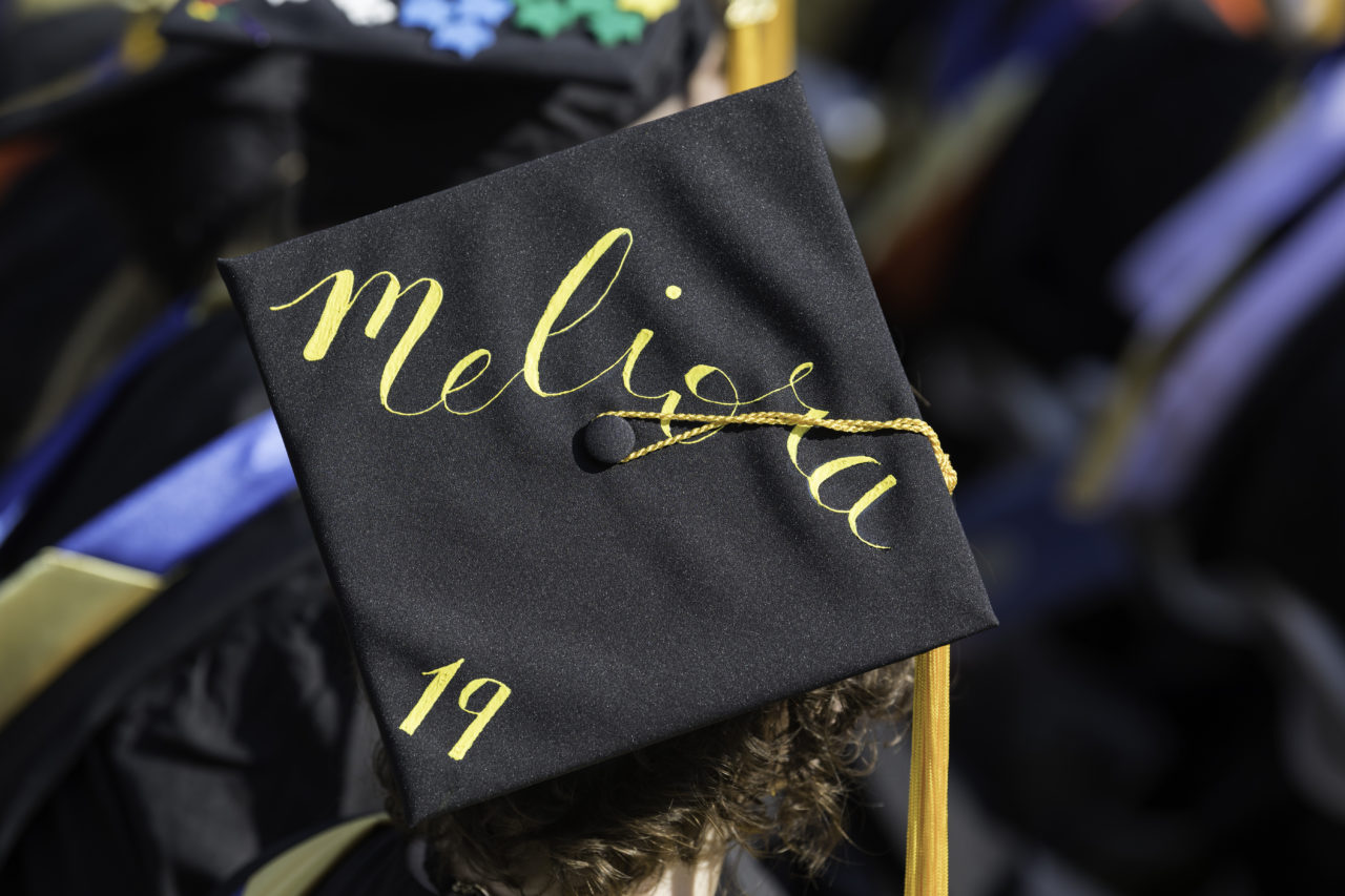 A University of Rochester graduation hat with the "Meliora" insignia written on it