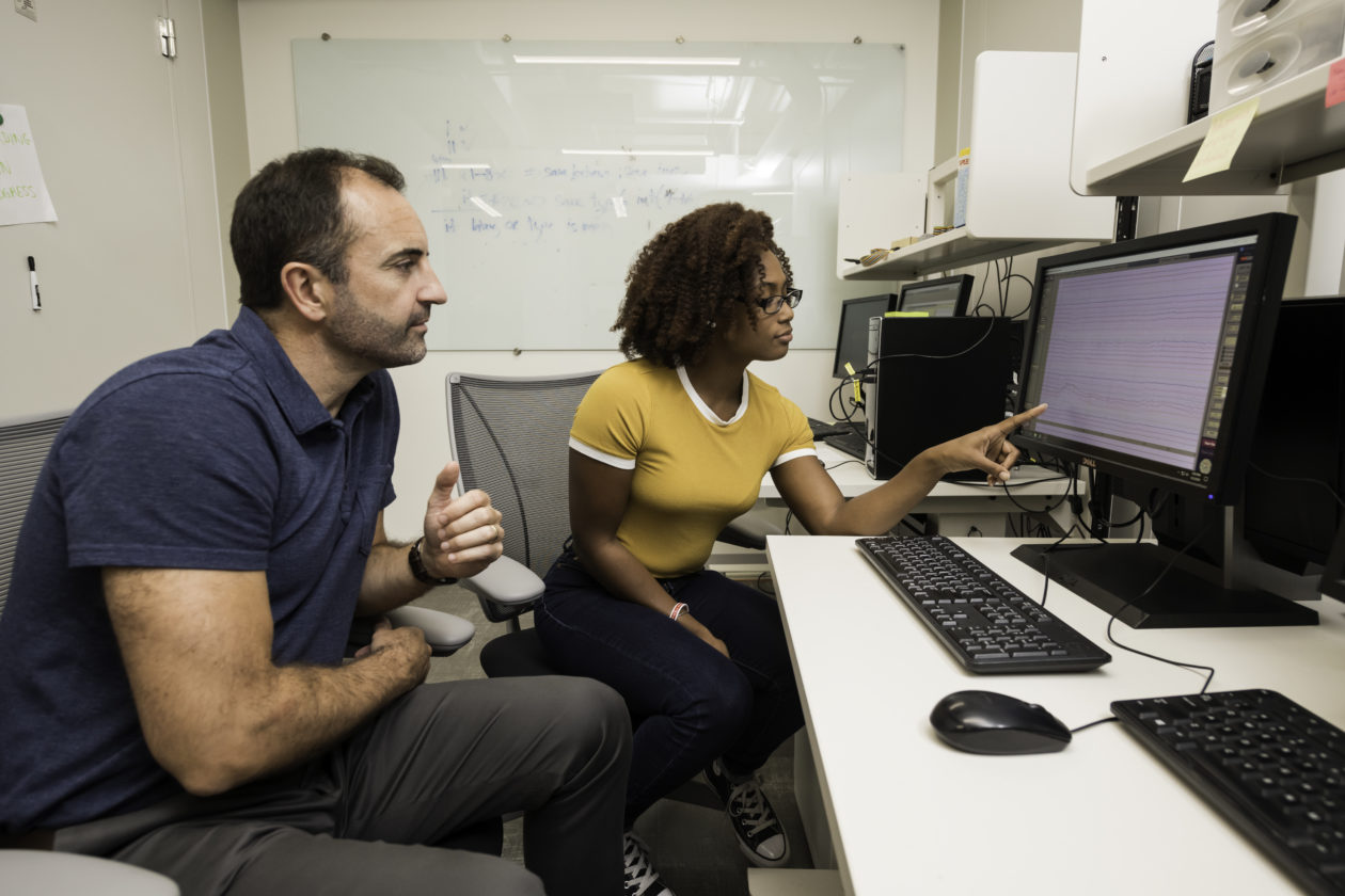 A University of Rochester student and professor collaborate on a computer