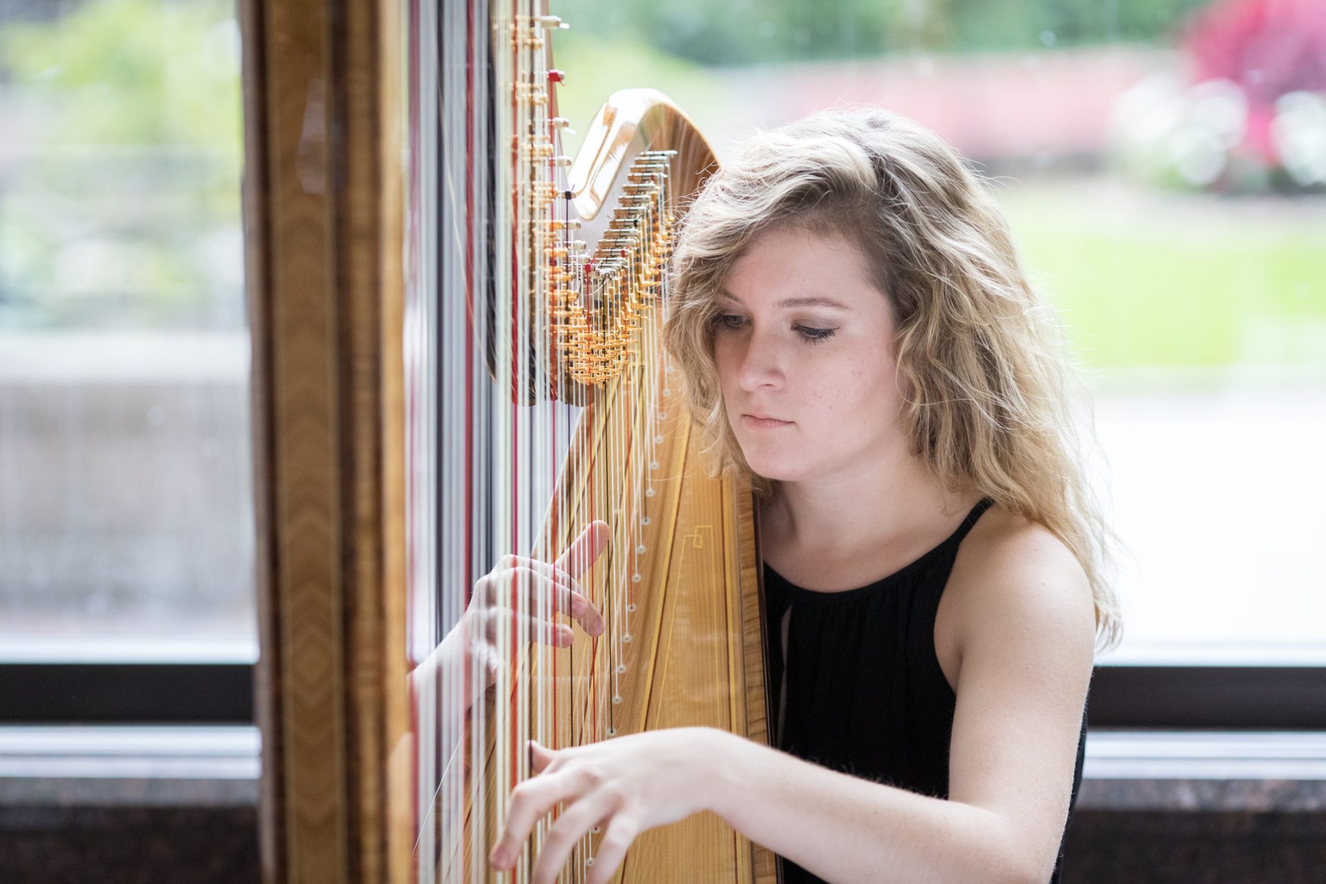 A University of Rochester student playing the harp
