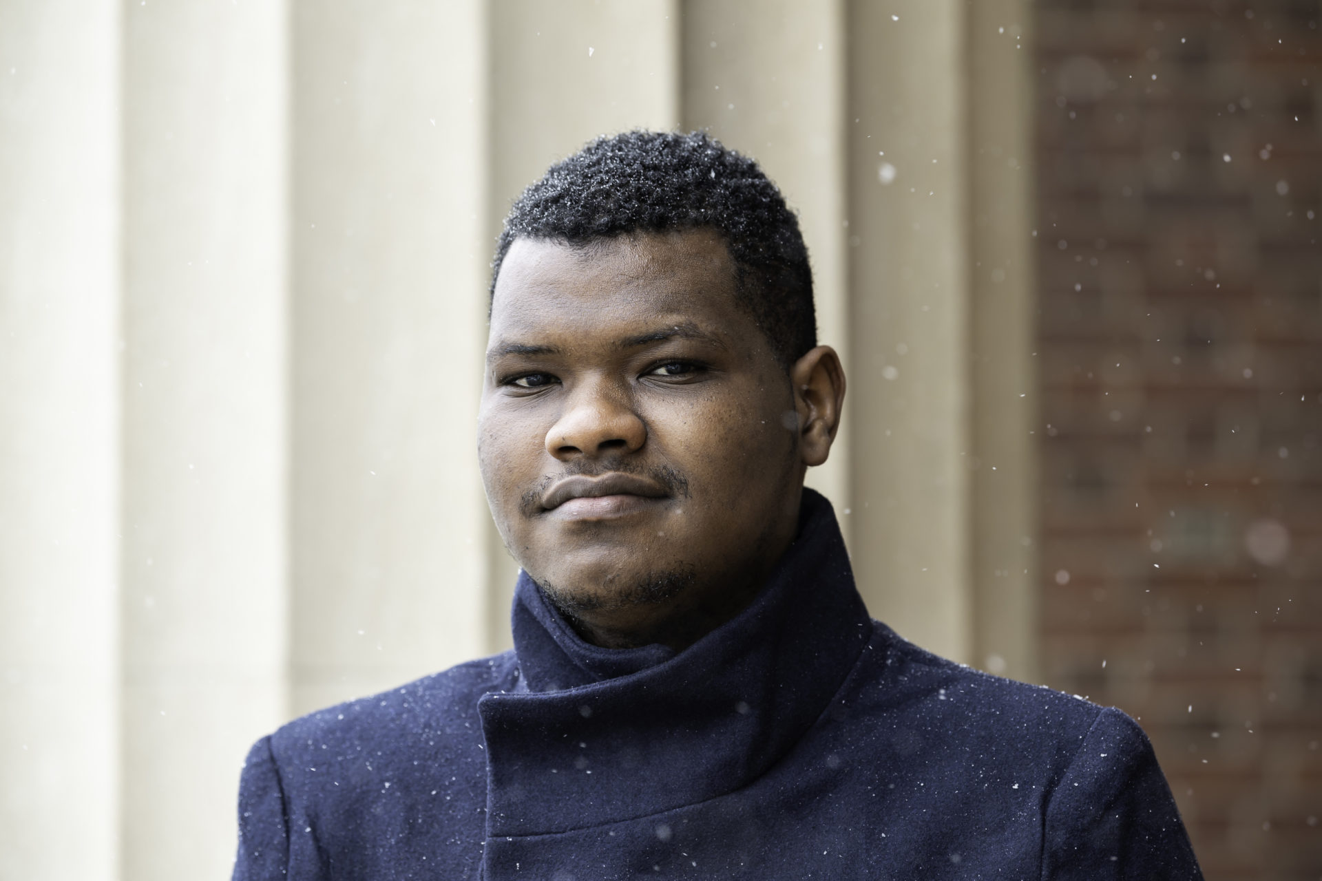 A University of Rochester international student portrait, outside on a snowy day