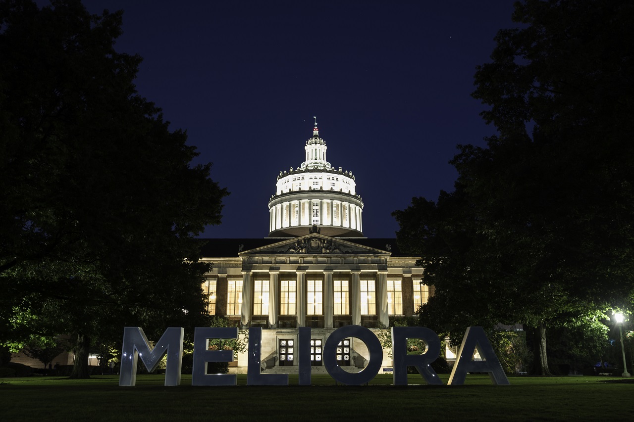 Meliora letters on Eastman Quad, pictured at twilight.