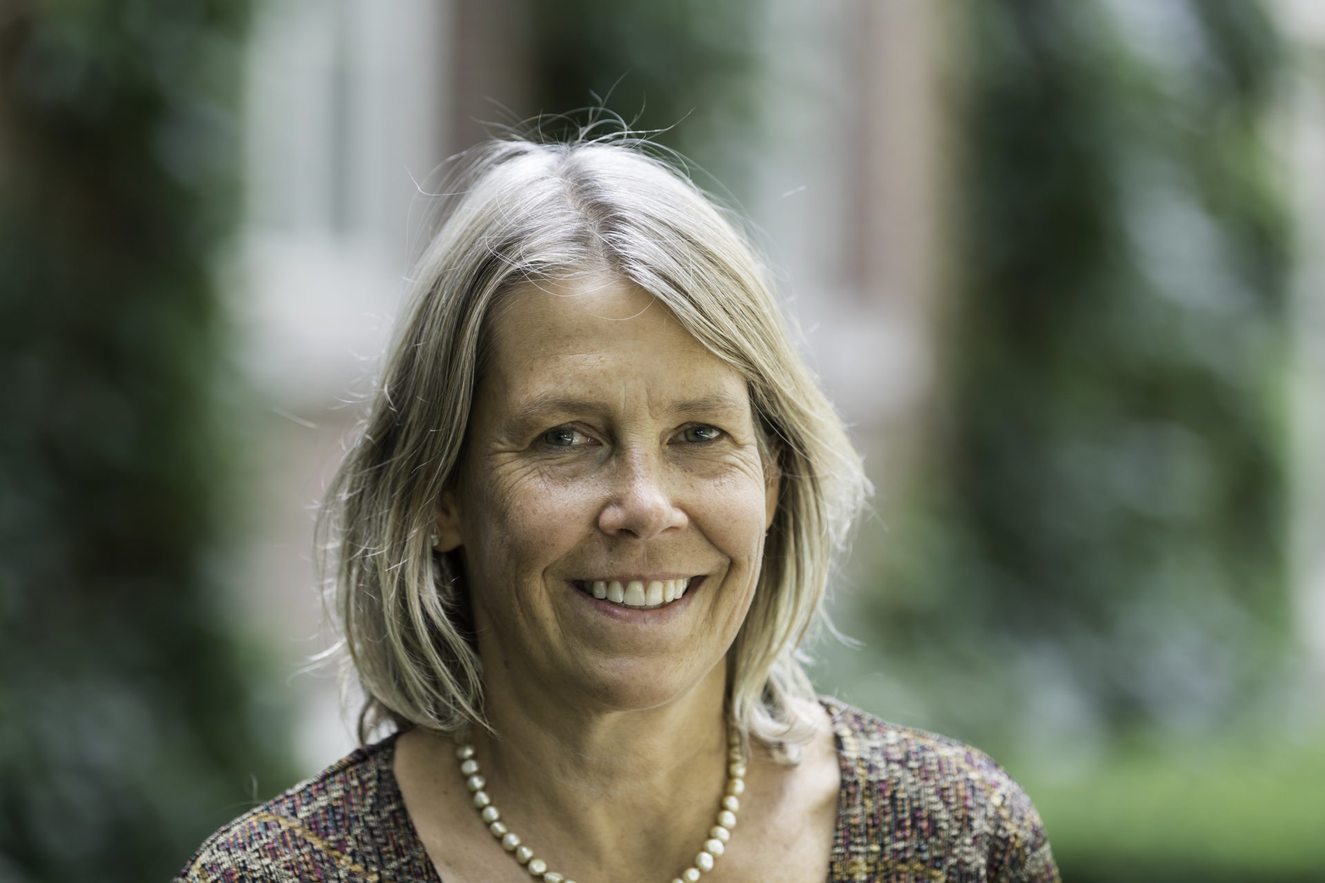 A headshot of a University of Rochester professor outside on campus