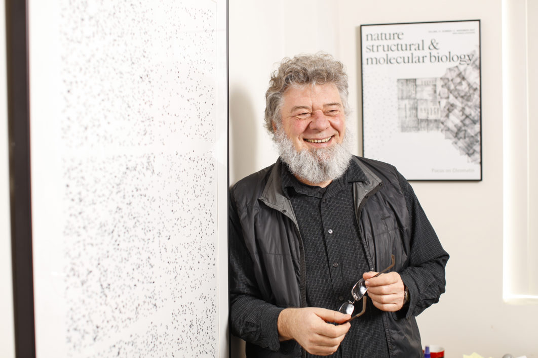 A University of Rochester professor in a classroom in front of a white board