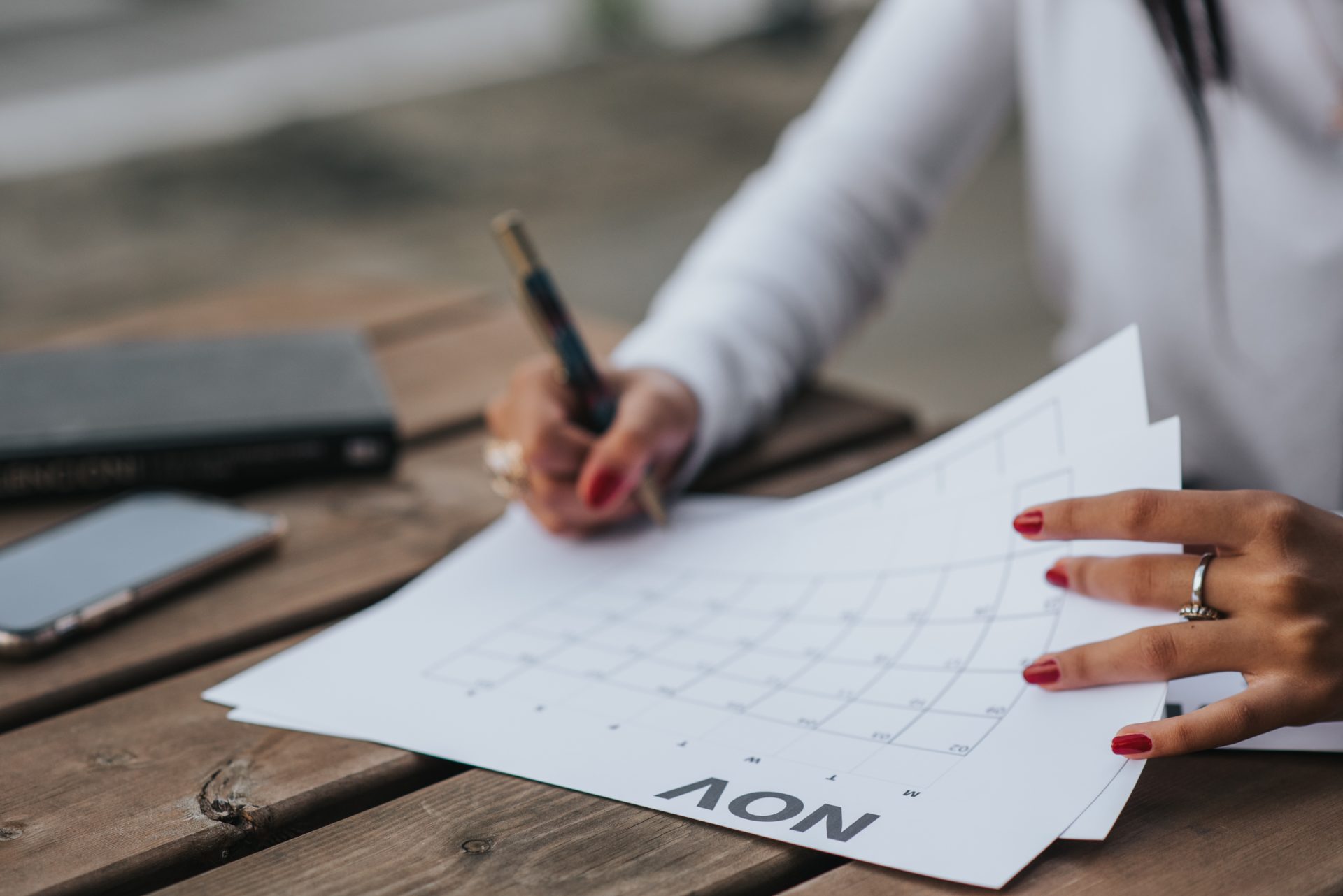 A person writing on a calendar
