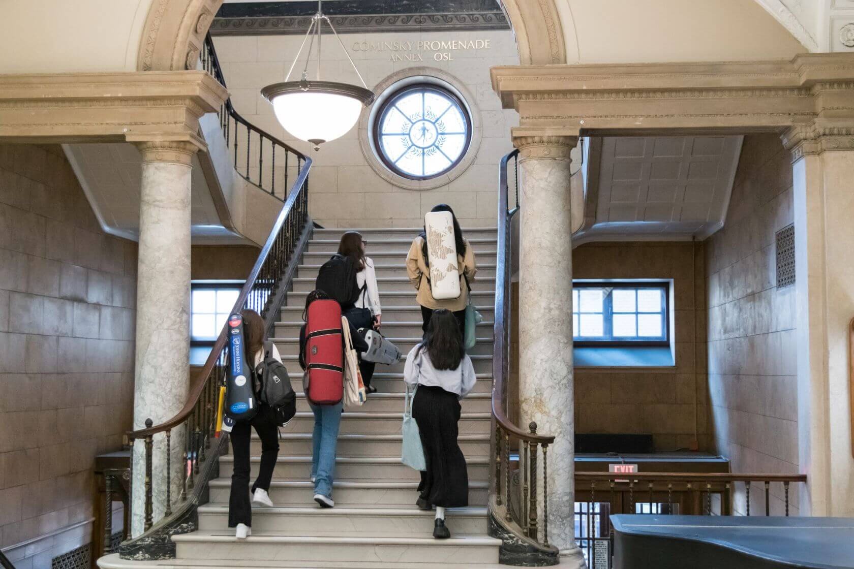 A group of students make their way up a staircase on their way to class at the University of Rochester, Eastman School of Music.