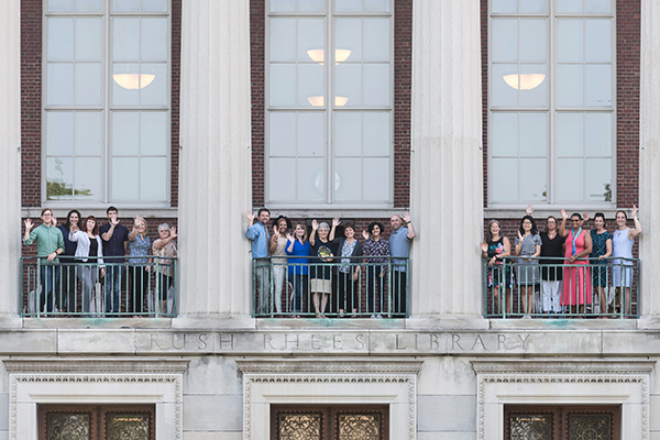 Staff members grouped in the windows of Rush Rhees Library.