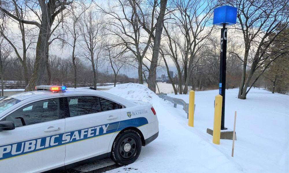 Public Safety patrol car beside a blue light phone
