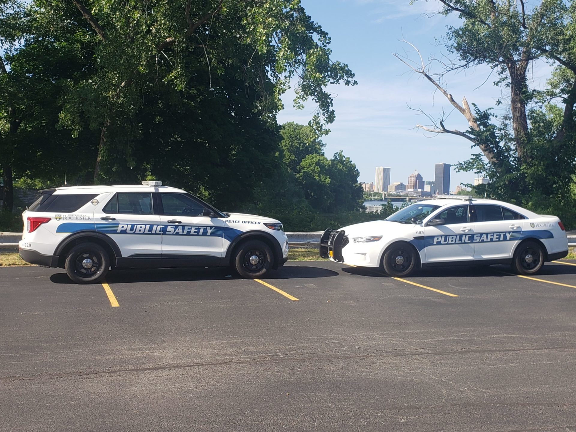 Two public safety patrol cars in a parking lot