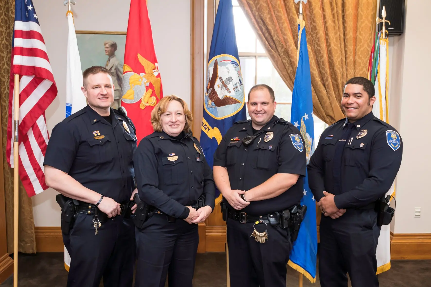 A group of University of Rochester Public Safety officers posing for the camera after a pinning ceremony