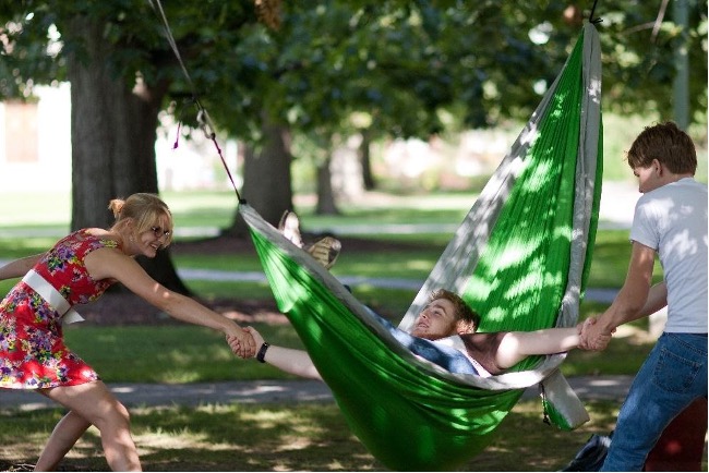 Three students hanging out on the quad.
