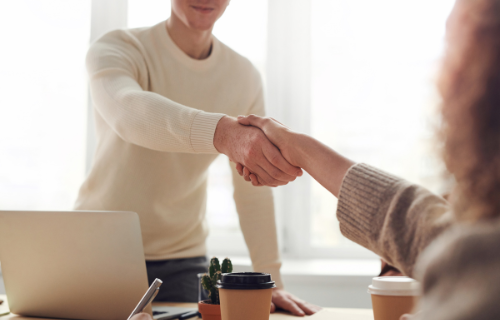 a photo of a person shaking another persons hands.