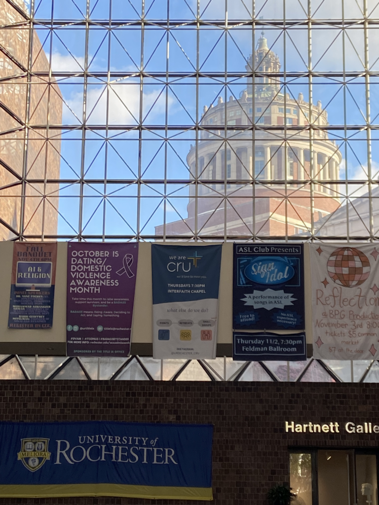A photo of the October banner hanging in Wilson Commons. This is an annual banner that brings the start of October; dating and domestic violence awareness month to the University's attention as a call to action.