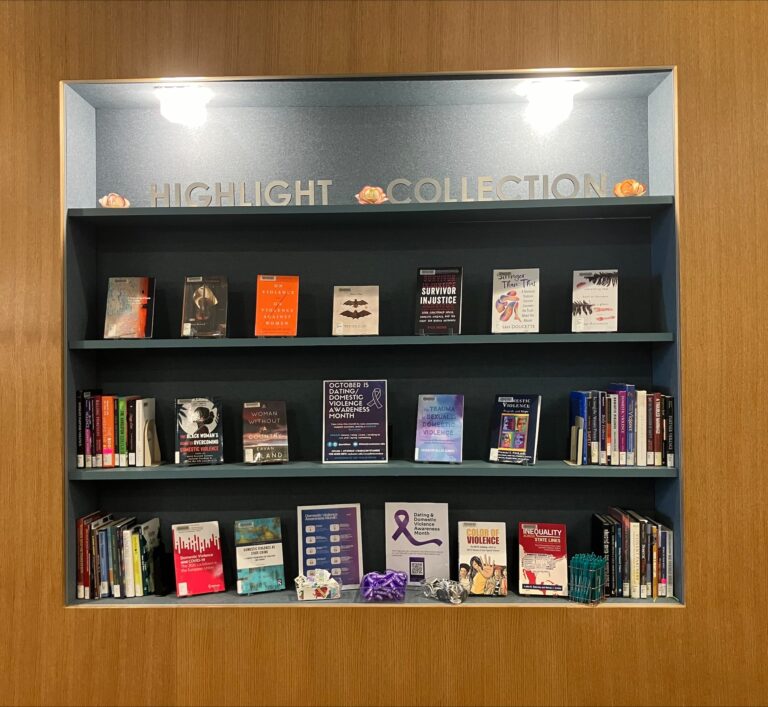 A photo of the annual October book display in Rush Rhees Library showing a collection curated by Librarians and Title IX Staff for Dating and Domestic Violence Awareness Month