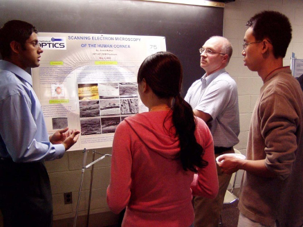 A group discussion at a poster presentation.