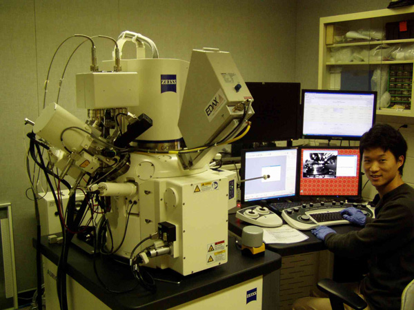 A researcher using equipment in a lab.