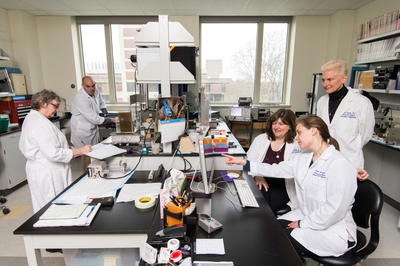 A group of researchers collaborating in a lab
