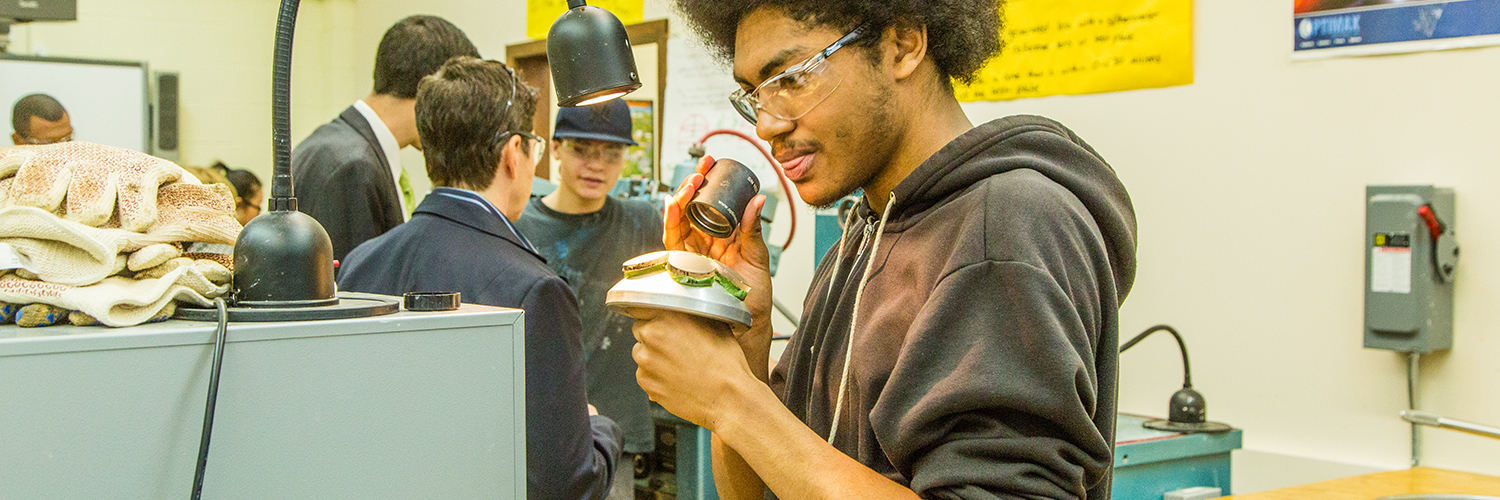 Student examining a lens in the optics lab