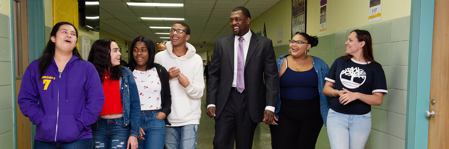 Superintendent Shaun Nelms walking down the hallway with a group of students