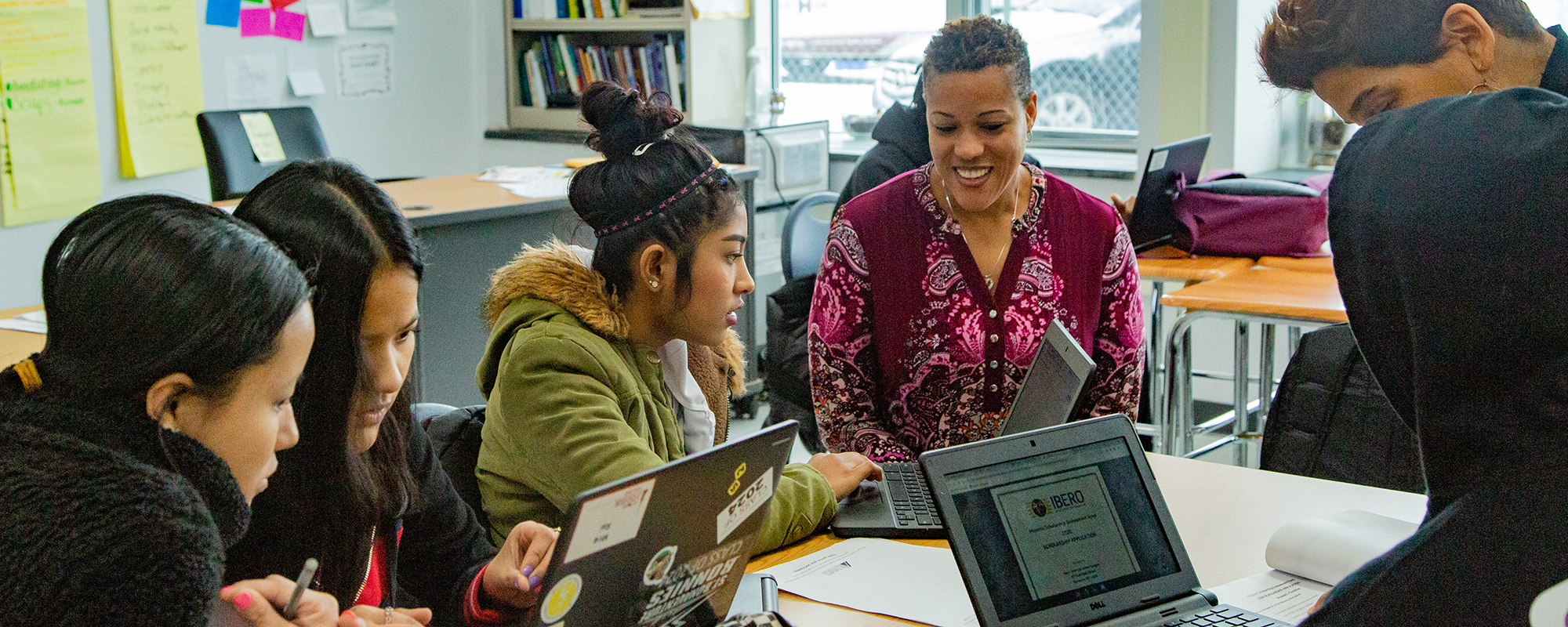 Teachers helping students in family group