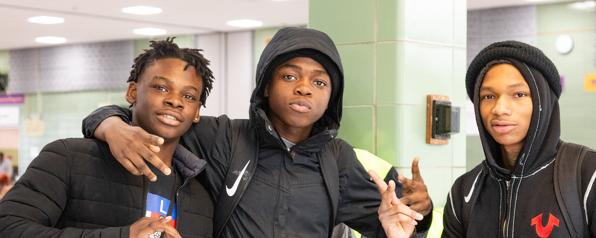 Three teen boys in the cafeteria