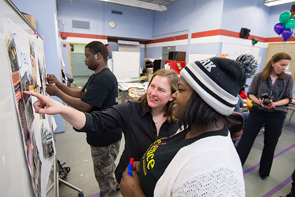 2015-04-14_Science_Stars_219 educator working with student on display