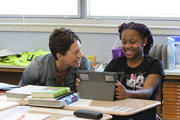 IMG_5301 a teacher and student smile while working at an ipad
