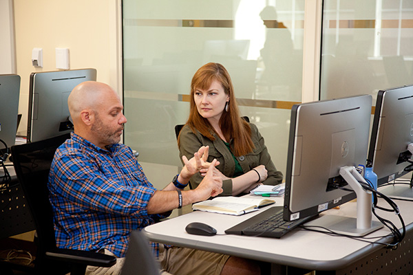 two educators talking in computer lab