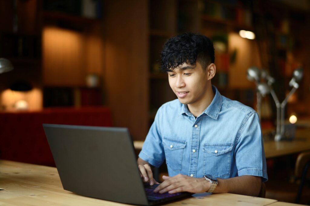 A student using his laptop in a University library